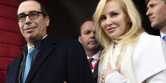 FILE - In this Friday, Jan. 20, 2017, file photo, then Treasury Secretary-designate Stephen Mnuchin and his then-fiancee, Louise Linton, arrive on Capitol Hill in Washington, for the presidential inauguration of Donald Trump. Linton responded to a social media critic on Aug. 21, 2017, telling the mother of three that that she was ââ¬Åadorably out of touch.ââ¬Â Mnuchin and Linton were married in June. (Saul Loeb/Pool Photo via AP, File)
