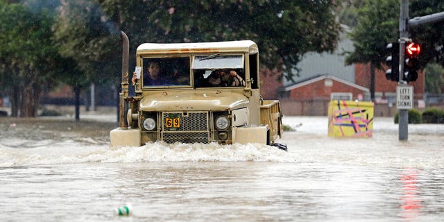 A truck pushes through floodwaters in Houston, Texas.