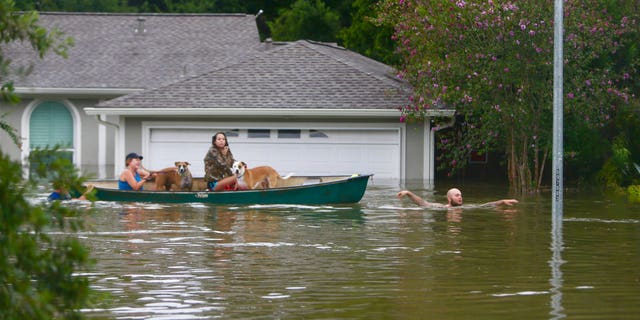 A family evacuates their Meyerland home in Houston, Texas.
