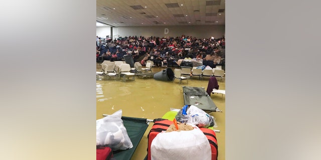 Evacuees sit in the bleachers at the Bowers Civic Center in Port Arthur.