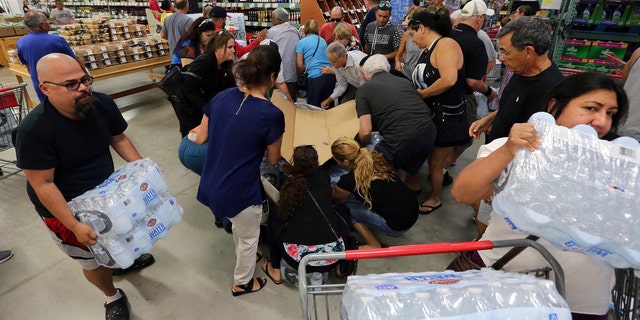 Residents purchase water at BJ Wholesale in preparation for Hurricane Irma Tuesday, Sept. 5, 2017, in Miami.