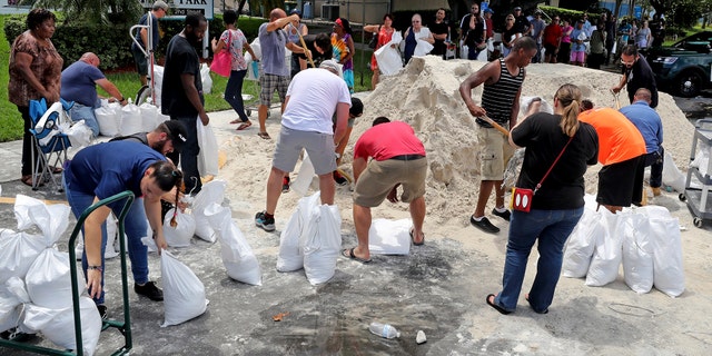 Residents line up at Frost Park in Dania Beach, Fla., and fill up sandbags in preparation of Hurricane Irma in Dania Beach, Fla., on Thursday, Sept. 7, 2017.