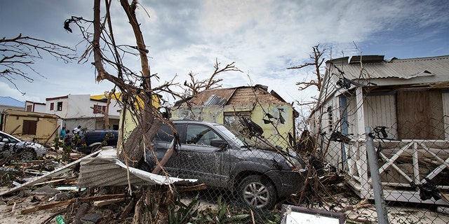 Storm damage, including destroyed vehicles, in the aftermath of Hurricane Irma on St. Maarten.
