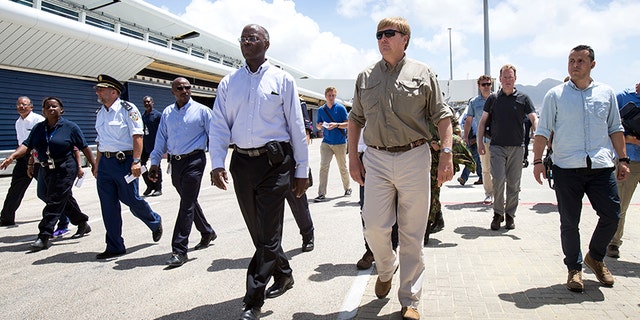 Dutch King Willem-Alexander, center right, visiting after the passing of Hurricane Irma on St. Maarten.