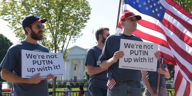 Protesters gather at the White House in Washington, Saturday, Sept. 16, 2017, during a rally encouraging President Donald Trump and House Speaker Paul Ryan to defend American democracy from Russian interference. (AP Photo/Susan Walsh)