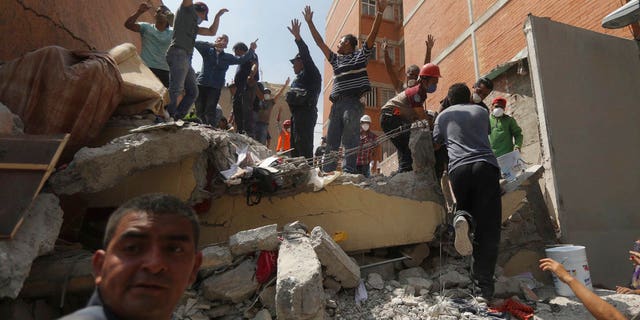 Rescue workers and volunteers search for survivors in the aftermath of a 7.1 magnitude earthquake.