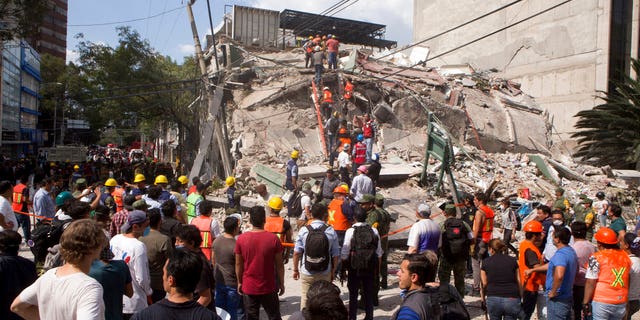 Volunteers and first responders look for survivors in a collapsed building after an earthquake struck Mexico City on Tuesday.