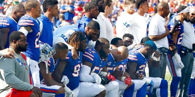 Buffalo Bills players take a knee during the national anthem Sept. 24 ahead of their game against the Denver Broncos.