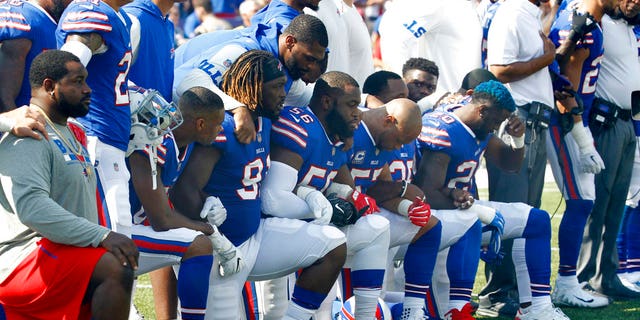 Buffalo Bills players take a knee during the national anthem Sept. 24 ahead of their game against the Denver Broncos.