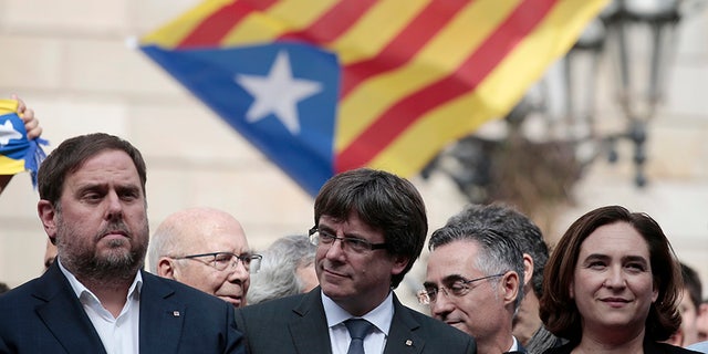 Catalan President Carles Puigdemont (center) says the region is set to declare its independence from Spain "in a matter of days."