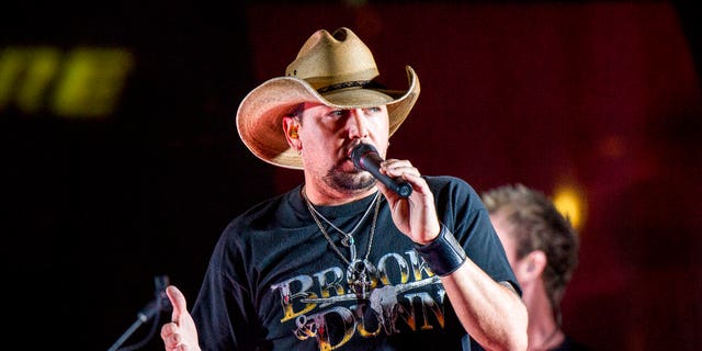 FILE - In this June 7, 2017 file photo Jason Aldean performs during a surprise pop up concert at the Music City Center in Nashville, Tenn. Aldean was the headlining performer when a gunman opened fire at a music festival on the Las Vegas Strip on Sunday, Oct. 1. (Photo by Amy Harris/Invision/AP, File)