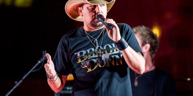 FILE - In this June 7, 2017 file photo Jason Aldean performs during a surprise pop up concert at the Music City Center in Nashville, Tenn. Aldean was the headlining performer when a gunman opened fire at a music festival on the Las Vegas Strip on Sunday, Oct. 1. (Photo by Amy Harris/Invision/AP, File)