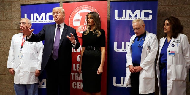 President Donald Trump talks as first lady Melania Trump and surgeon Dr. John Fildes, left, listens at the University Medical Center after Trump met with survivors of the mass shooting Wednesday, Oct. 4, 2017, in Las Vegas. (AP Photo/Evan Vucci)