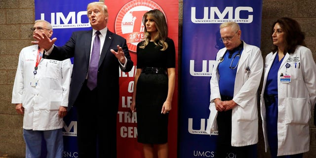 President Donald Trump talks as first lady Melania Trump and surgeon Dr. John Fildes, left, listens at the University Medical Center after Trump met with survivors of the mass shooting Wednesday, Oct. 4, 2017, in Las Vegas. (AP Photo/Evan Vucci)