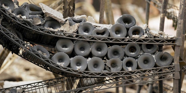 A rack of burned bottles of wine are seen at the Signorello Estate winery Tuesday, one of the few wineries destroyed by the wildfire.