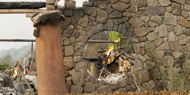 Flames continue to smolder at the Signorello Estate winery Tuesday.