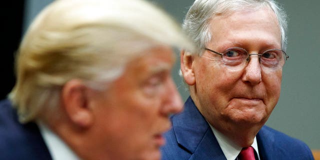In this Sept. 5, 2017 file photo, Senate Majority Leader Mitch McConnell, R-Ky., right, listens as President Donald Trump speaks during a meeting with Congressional leaders and administration officials in the Roosevelt Room of the White House in Washington.