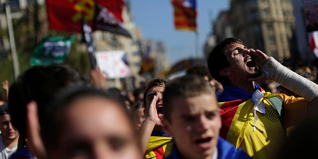 Students shout out as they march during a protest against the Spanish government announcement of implementing the article 155 in the Catalonia region, in Barcelona, Spain, Thursday Oct. 26, 2017. The Catalan parliament is due to meet to discuss Spanish government's plans to remove the leaders of the regional government. (AP Photo/Emilio Morenatti)