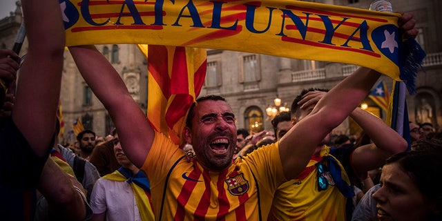 Pro-independence demonstrators cheer outside the Catalan parliament, in Barcelona, Oct. 27, 2017.