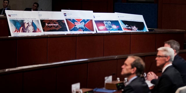 Facebook ads linked to a Russian effort to disrupt the American political process are displayed as, from left, Google's Senior Vice President and General Counsel Kent Walker, Facebook's General Counsel Colin Stretch, and Twitter's Acting General Counsel Sean Edgett, testify during a House Intelligence Committee hearing.