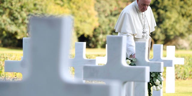 Pope Francis pays a visit to the American military cemetery in Nettuno, Italy, Thursday, Nov. 2, 2017. Pope Francis is underlining the price of war, visiting an American military cemetery and the site of a Nazi massacre in Rome. The pope will first say Mass in the Sicily-Rome American Cemetery, where 7,680 American war dead who helped liberate southern and central Italy during World War II are buried and 3,095 missing are commemorated. (L'Osservatore Romano/Pool Photo via AP)