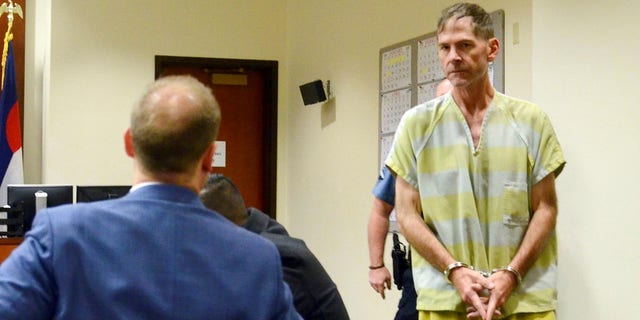 Scott Ostrem, 47, suspected of fatally shooting three people inside a suburban Denver Walmart, enters a courtroom in Brighton, Colo. on Monday.