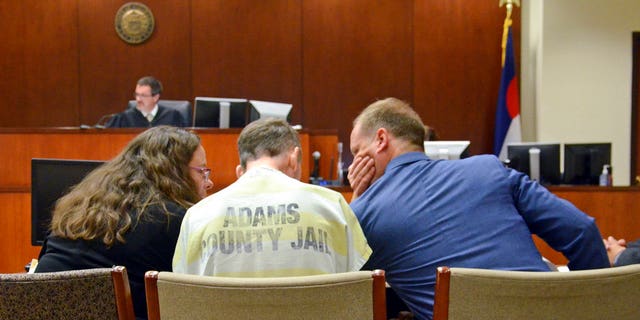 Scott Ostrem suspected of fatally shooting three people inside a suburban Denver Walmart, confers with counsel in a courtroom.