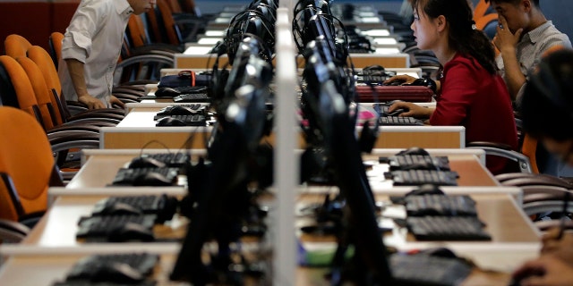 North Korean men and women use computer terminals at the Sci-Tech Complex in Pyongyang, North Korea, June 16, 2017.