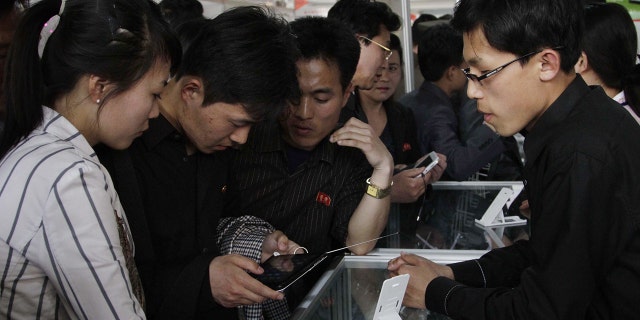 In this May 15, 2013, file photo, North Koreans take a look at the Samjiyon tablet computer produced for the North Korean market for sale at the 16th Pyongyang Spring International Trade Fair in Pyongyang.