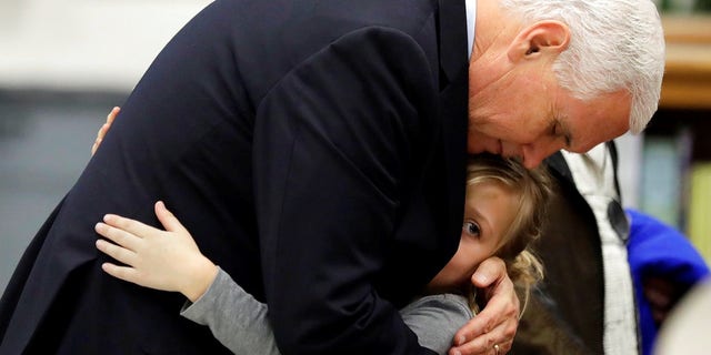 Vice President Pence hugs Evelyn Hill at Florseville High School during a stop in Texas to comfort those affected by the church shooting.
