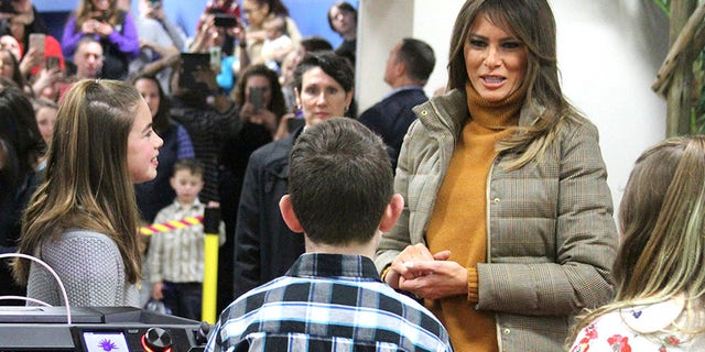 First lady Melania Trump listens as children tell her about 3D printing at Joint Base Elmendorf-Richardson, Alaska.