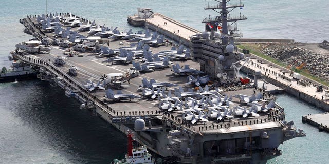 USS Ronald Reagan (CVN 76) is escorted into Busan port, South Korea, after completing a joint drill with the South Korean military.