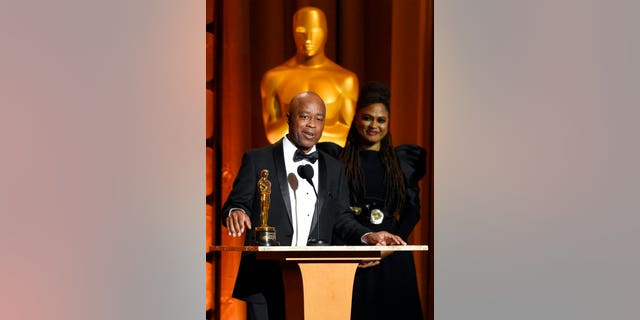 Film director Charles Burnett accepts an honorary Oscar.
