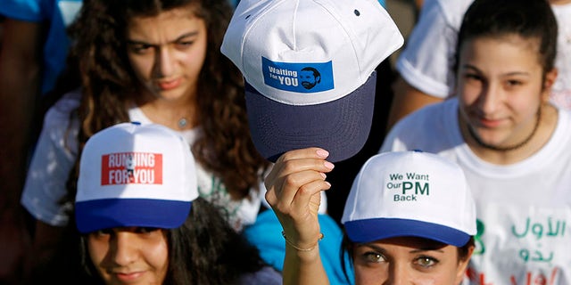 Runners and spectators at the 15th annual Beirut marathon wore hats and held signs in support of Lebanese PM Saad Hariri.