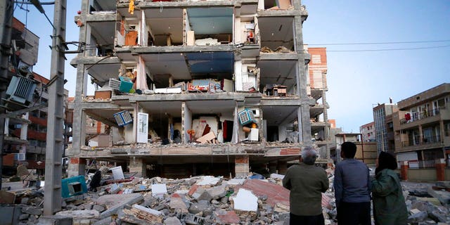 People looked at destroyed buildings after an earthquake at the city of Sarpol-e-Zahab in western Iran on Monday.