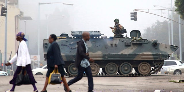 An armed soldier patrols a street in Harare, Zimbabwe, Wednesday, Nov. 15, 2017. Zimbabwe's army said Wednesday it has President Robert Mugabe and his wife in custody and is securing government offices and patrolling the capital's streets following a night of unrest that included a military takeover of the state broadcaster. (AP Photo)