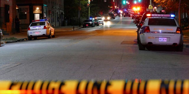 Police officers respond to Bennett Place and N. Fremont Avenue after a call went out that an officer was shot Wednesday in Baltimore, M.D.