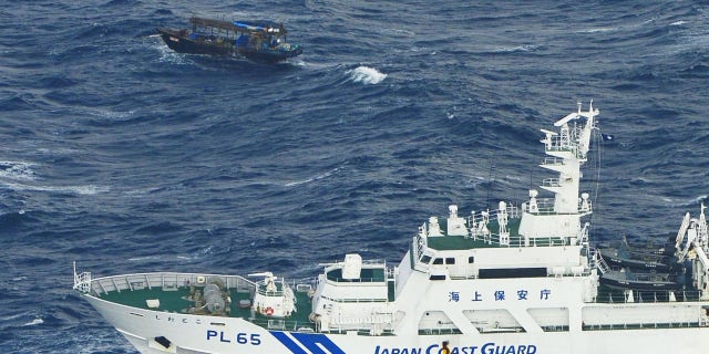 The Japanese Coast Guard approached the drifting wooden boat Wednesday to inspect it and the North Korean men aboard.