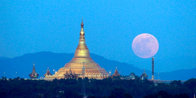 The moon rises behind the mountain range seen from Naypyitaw, Burma, on Sunday.