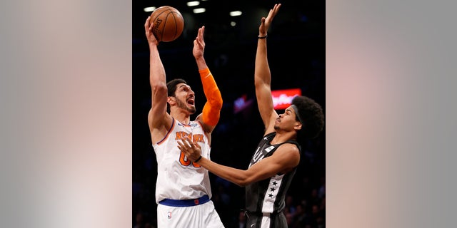 Enes Kanter, left, of the New York Knicks, plays against the Brooklyn Nets in an NBA game in New York City, Dec. 14, 2017.