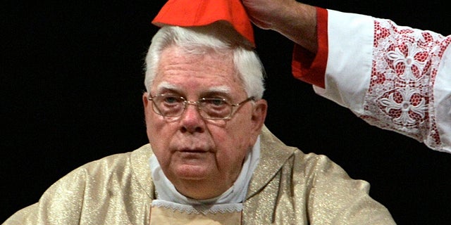 Cardinal Bernard Law has his skull cap adjusted during a ceremony in St. Mary Major's Basilica in Rome, Aug. 5, 2004.