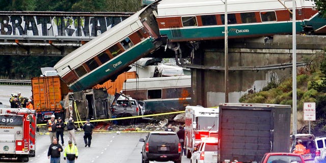 Several train cars fell over the overpass and onto Interstate 5 in Washington state on Monday.
