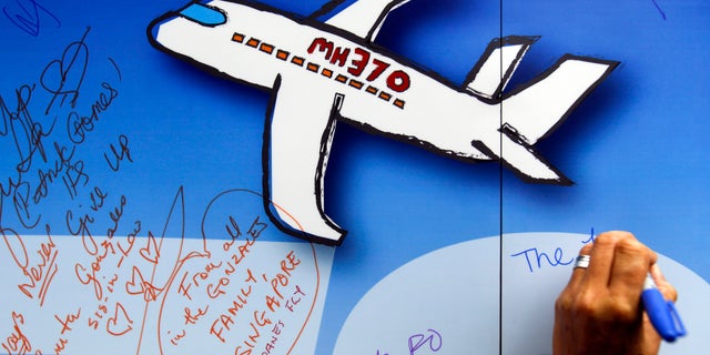 In this March 2016 file photo, well wishers have written on a wall of hope during a remembrance event for the missing Malaysia Airlines Flight 370 in Kuala Lumpur, Malaysia. The Malaysian government has approved a new attempt to find the wreckage of Malaysia Airlines Flight 370 in the Indian Ocean.