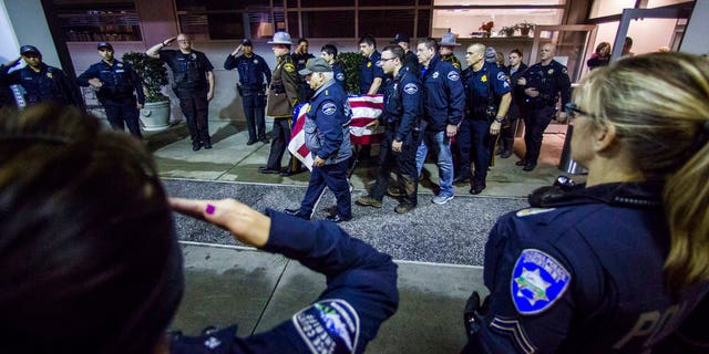 Officers and medical staff take part in a procession for officer Daniel McCartney, of Yelm, at St. Joseph Medical Center in Tacoma, Wash., on Monday, Jan. 8, 2018.