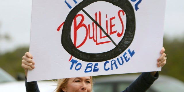 On Monday, concerned parents and family members protested bullying near Surfside Middle School, in Panama City Beach, Fla.