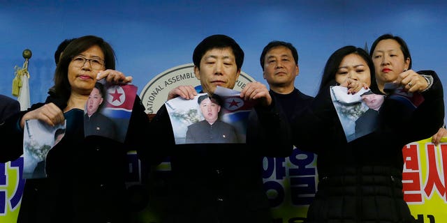 South Korean protesters ripped up photos of Kim Jong Un in protest ahead of the Winter Olympics.