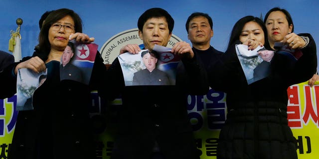 South Korean protesters ripped up photos of Kim Jong Un in protest ahead of the Winter Olympics.