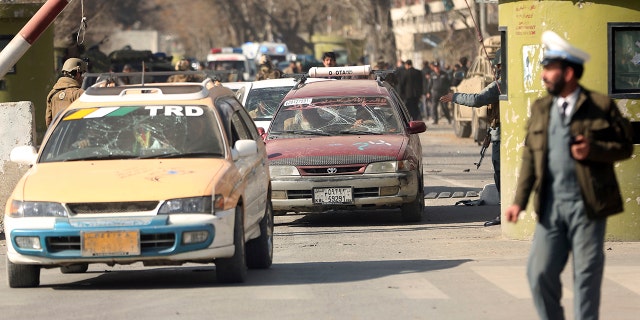 Security forces inspect at the site of a deadly suicide attack in the center of Kabul, Afghanistan.