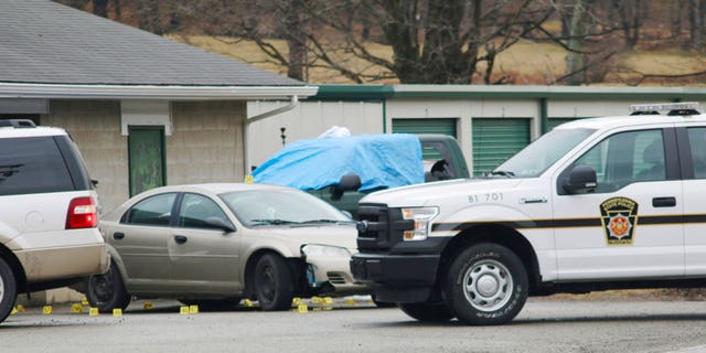 Evidence markers sit on the scene of a fatal shooting at a car wash in Melcroft, Pa., Sunday, Jan. 28, 2018.