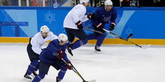 United State's Ryan Gunderson battles controls the puck against Mark Arcobello, left, during practice ahead of the 2018 Winter Olympics in Gangneung, South Korea, Friday, Feb. 9, 2018. (AP Photo/Kiichiro Sato)